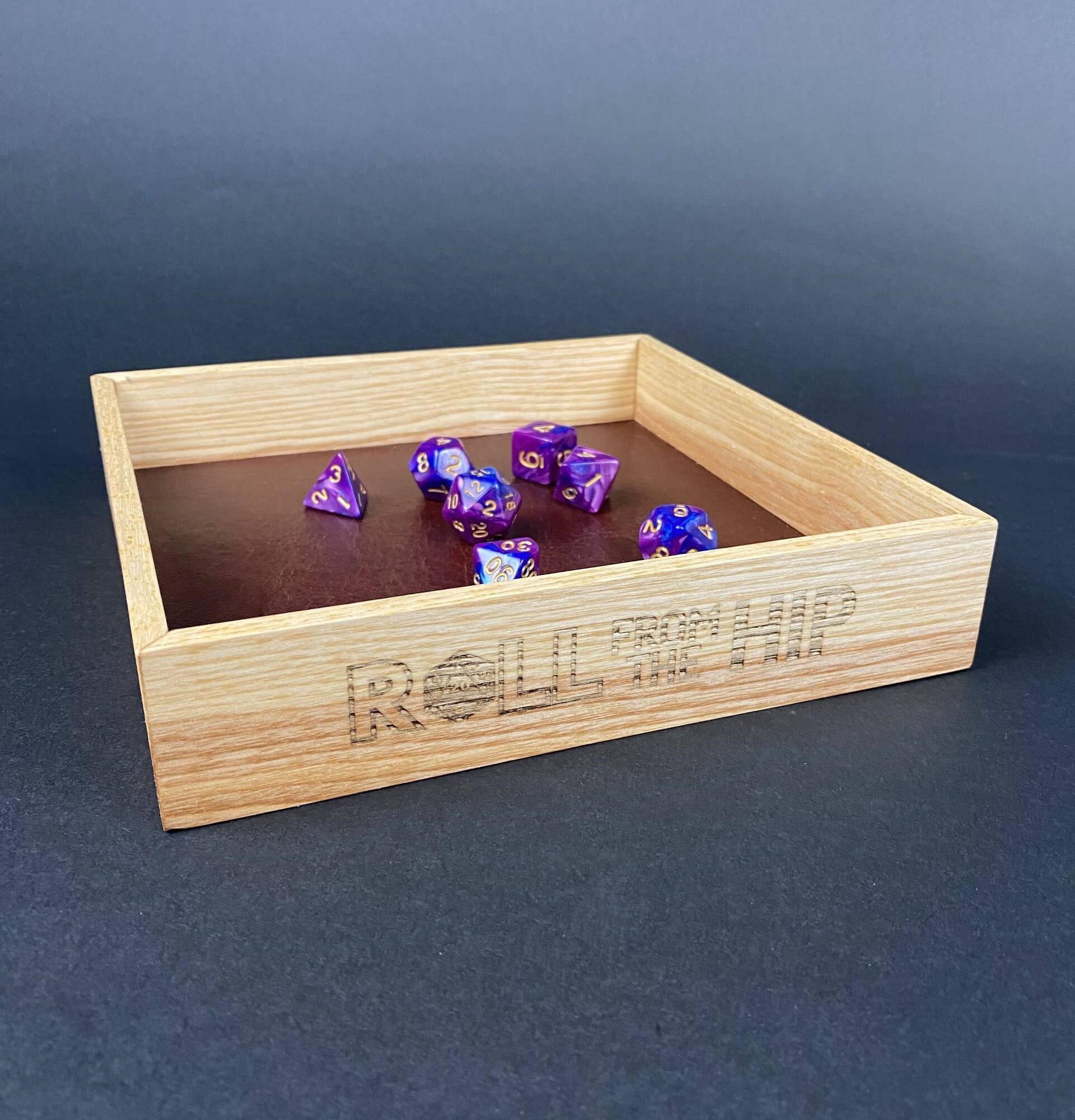 Roll From The Hip branded Ash Dice Tray (shown with dice) by Silverwood Gaming. Brand on display more fully